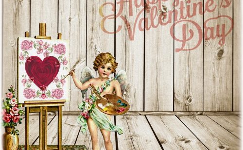 Happy Valentine's Day の文字とキャンパスにハートとピンクの薔薇の絵を描いてるキューピットのイラスト